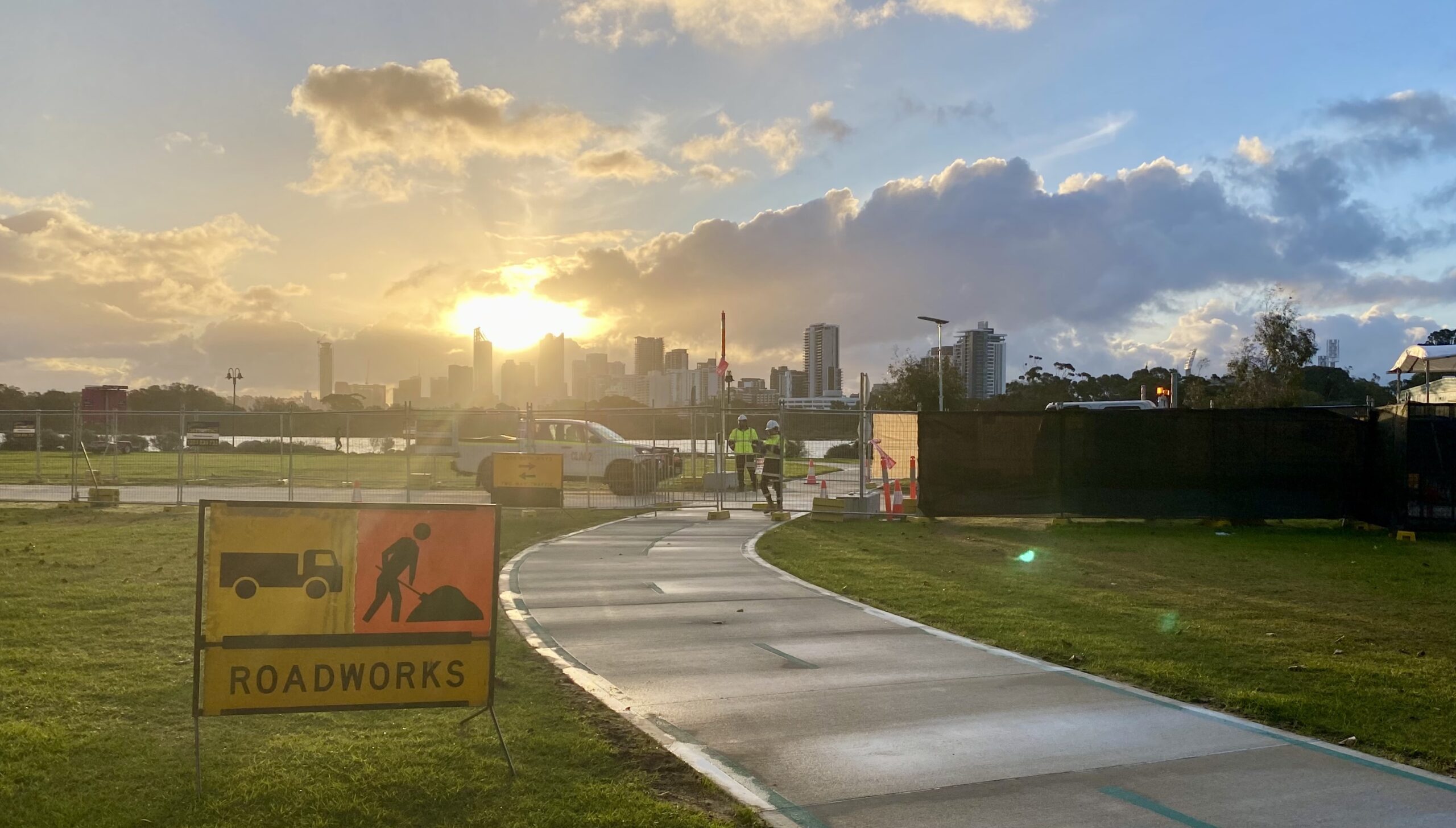 photo of a temporary concrete path at the construction site for the new pedestrian and cyclist bridge at the Causeway in Perth, looking into the setting sun.